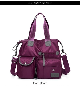 Front view of a purple multi-pocket waterproof nylon travel tote bag with shoulder strap