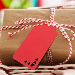Brown paper gift wrap with red-white cotton string and a red heart hollow hang tag