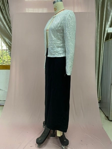 Detail of white sequin cropped jacket with vertical silver sparkles and stand collar