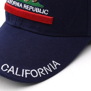 Macro shot of California Republic embroidery on the navy blue cotton baseball cap