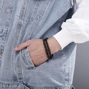 Close-up of matte black double-layered stainless steel curb and wheat chain bracelet