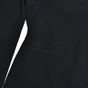 Detail of elegant black dress showing high-quality fabric texture and welt pocket