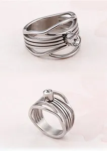 Macro detail of silver titanium steel hollow wide ring with brushed metal and bezel-set zircon