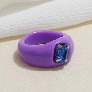 Retro resin ring in purple with a blue rectangle gemstone in a claw setting