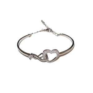 Silver infinity heart bracelet with white cubic zirconia on a white background