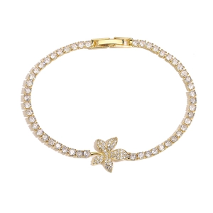 Elegant gold-plated leaf tennis bracelet with sparkling cubic zirconia on white background