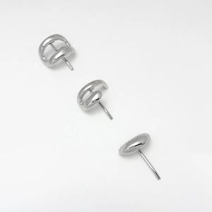 Detailed view of three minimalist silver-tone alloy earrings with polished geometric shapes