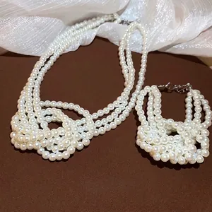 Elegant multi-layer knotted pearl necklace and bracelet set in warm cream white