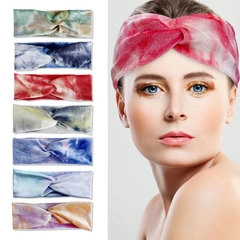 Detail of twisted tie-dye lace headband showing soft fabric texture and colorful patterns