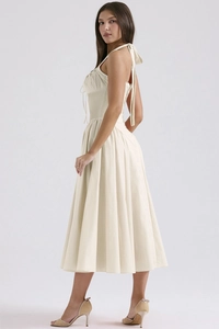 Detailed side view of a slim halter floral maxi dress with elegant back tie and flared hem