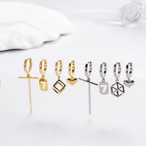 Detailed set of gold and silver earrings with heart, square, and long chain pendants
