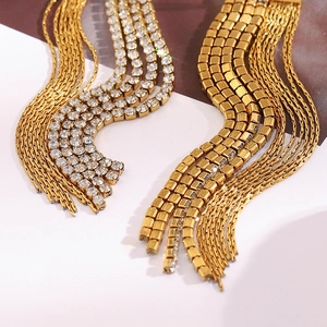 Detailed close-up of 18K gold plated chain tassel earrings with sparkling zircons