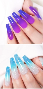 Detail view of long coffin nails in purple-pink and glittery blue-white thermal gradients