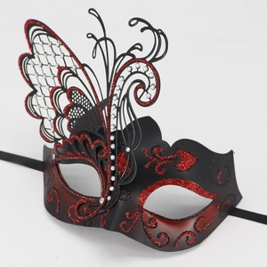Detail of red and black masquerade mask with glitter accents and sparkling rhinestones