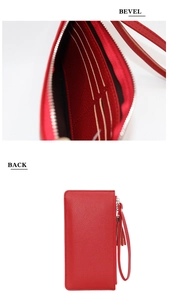 Detail view of red leather long wallet with card slots, zipper pockets and wrist strap
