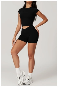 Full view of black short sleeve yoga crop top and tight athletic shorts set for women