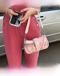 Close-up of pink Y2K baguette bag with silver star rivets and heart-shaped buckle detail