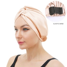 Close-up of champagne gold satin hair bonnet featuring an adjustable elastic band