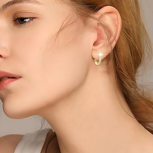 Close-up of S925 silver hoop earrings with pavé diamonds worn by a female model