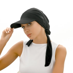 Detail of black turban hat with brim and long tie ribbons for a stylish fit