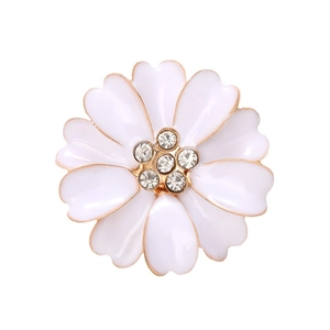 Elegant white enamel flower brooch with gold edges and sparkling rhinestone center