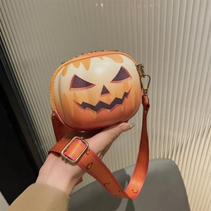 Detail of pumpkin-shaped crossbody bag with orange gradient and golden zipper hardware