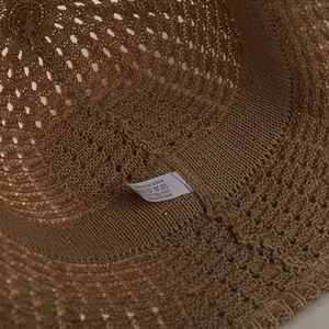 Detail of crochet sun hat interior showing 65% cotton blend fabric and woven texture