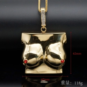 Detailed view of heavy gold pendant with red gem accents and precise measurement markings
