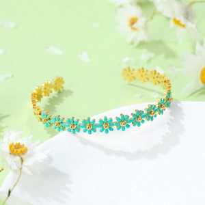 Daisy titanium steel bracelet with blue enamel flowers and a golden base finish