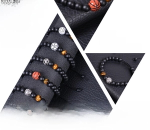 Detail showing natural 8mm tiger eye and matte agate beads with a basketball charm