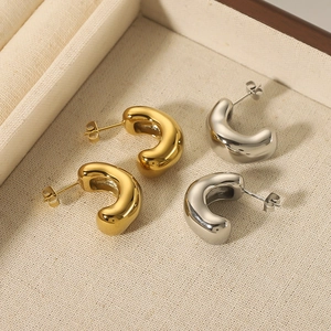 Irregular C-shaped stainless steel earrings in gold and silver finish, minimalist jewelry