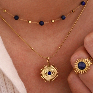 Layered 14K gold evil eye necklace with lapis lazuli beads and sunburst pendant set