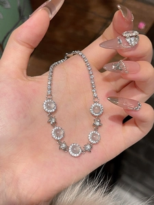 Detail of silver tennis bracelet with chalcedony flowers and sparkling zircon stars