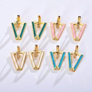 Macro view of geometric V-shaped earrings with colorful enamel and micro-set cubic zirconia