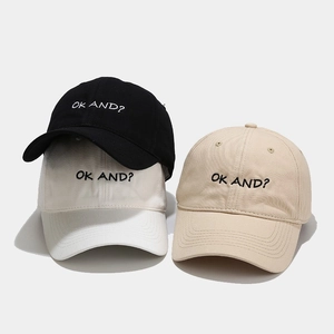 Three minimalist baseball caps in black, white, and beige with OK AND? embroidery