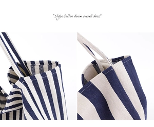 Detail shot of sturdy stitching and blue striped canvas texture on a large tote bag