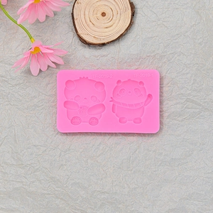 Macro detail of a pink silicone mold featuring two cute panda designs for cake decorating