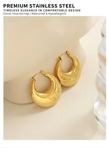 Macro shot of chunky gold U-shaped hoop earrings with a polished mirror finish