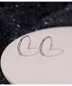 Detail of S925 silver U-shaped hook earrings with inlaid sparkling zircon stones