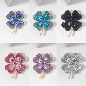 Close-up detail of clover brooches in six colors with crystals and alloy base
