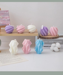 Artistic geometric twisted and spherical scented candles in pastel colors for home decor
