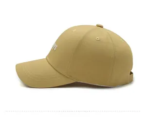 Side view of khaki baseball cap featuring white BOYS embroidery and six-panel structure