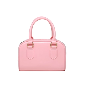Detail of pink jelly Boston bag featuring smooth finish and premium gold hardware accents