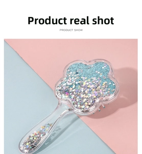 Close-up of transparent flower-shaped hairbrush filled with colorful star sequins
