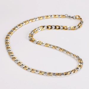 Close-up of hip-hop two-tone gold and silver curved bar Cuban link necklace on white background