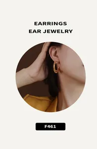 Detailed view of gold hoop earrings with beaded texture worn by a fashion model