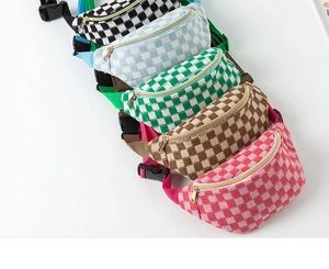 Detail view of checkered fanny packs with metal zippers and adjustable nylon straps