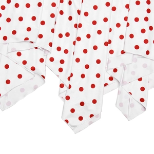 Close-up of lightweight fabric showing red polka dot pattern on white background