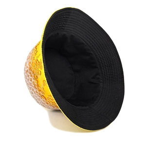 Detail of yellow beer pattern bucket hat showing canvas texture and black inner lining