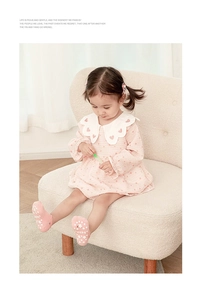 Detail of pink toddler dress with heart prints and matching non-slip star pattern socks